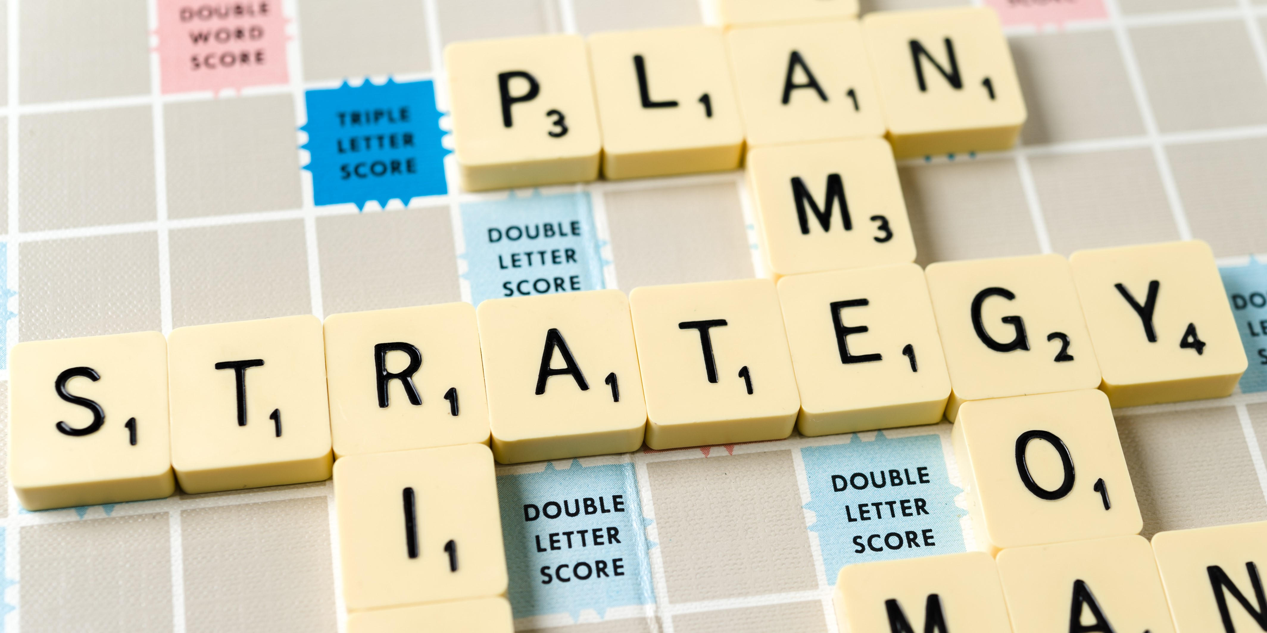 Close up of the word strategy on a vintage Scrabble board